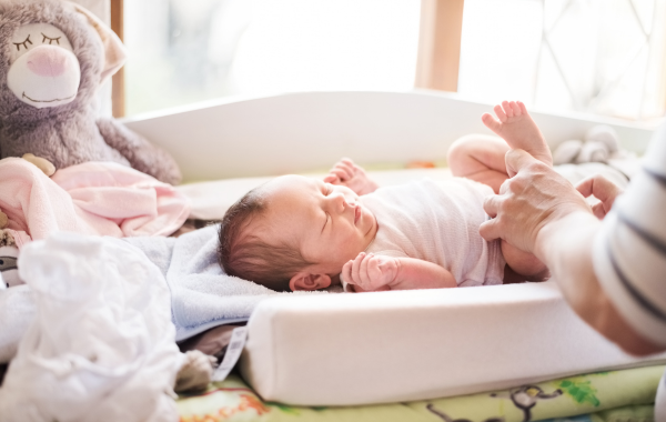 a baby lying on a changing table